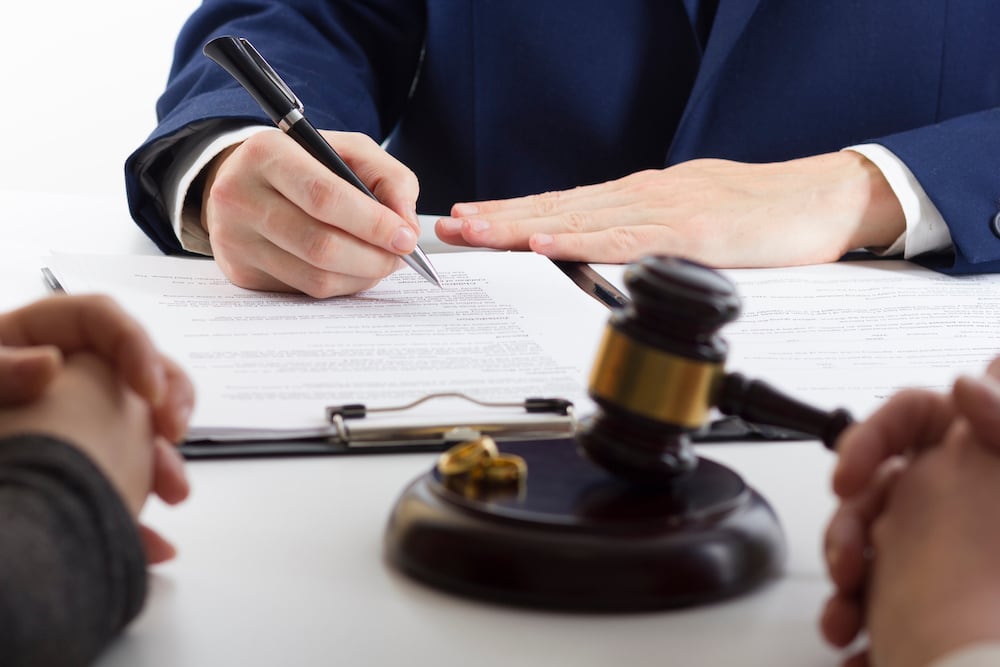 couple with lawyer drafting document