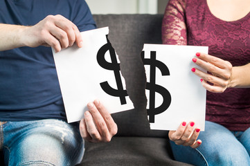 man and woman holding ripped paper with dollar sign on it