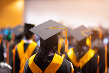 student in cap and gown at college graduation