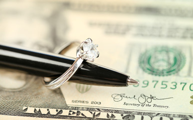wedding ring pen and money
