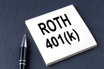 pen and paper that says roth 401k