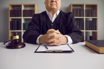 arbitrator with gavel and hands crossed