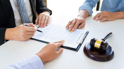 divorce lawyer with couple and rings and gavel