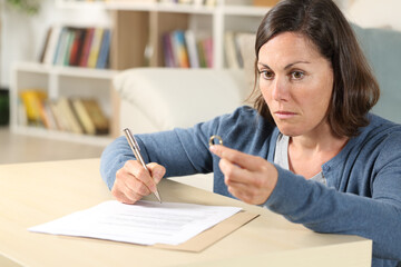 woman looking surprised at ring with divorce papers