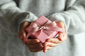 person's hands holding gift