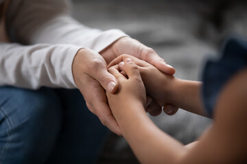 parent holding child's hands