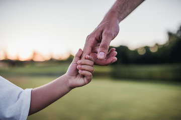 parent and child holding hands
