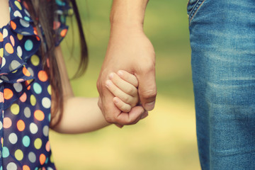 parent and child holding hands